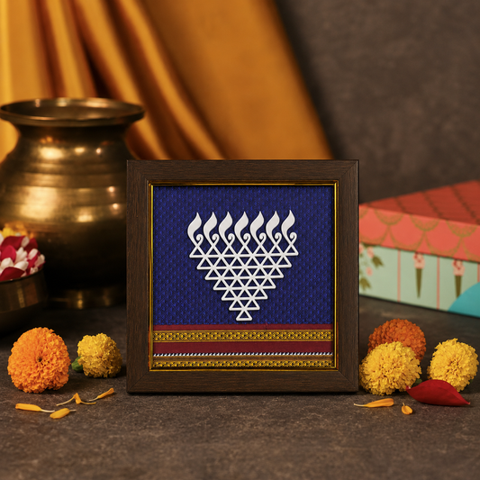 Decorative frame with a geometric design on a dark surface with flowers and a pot.
