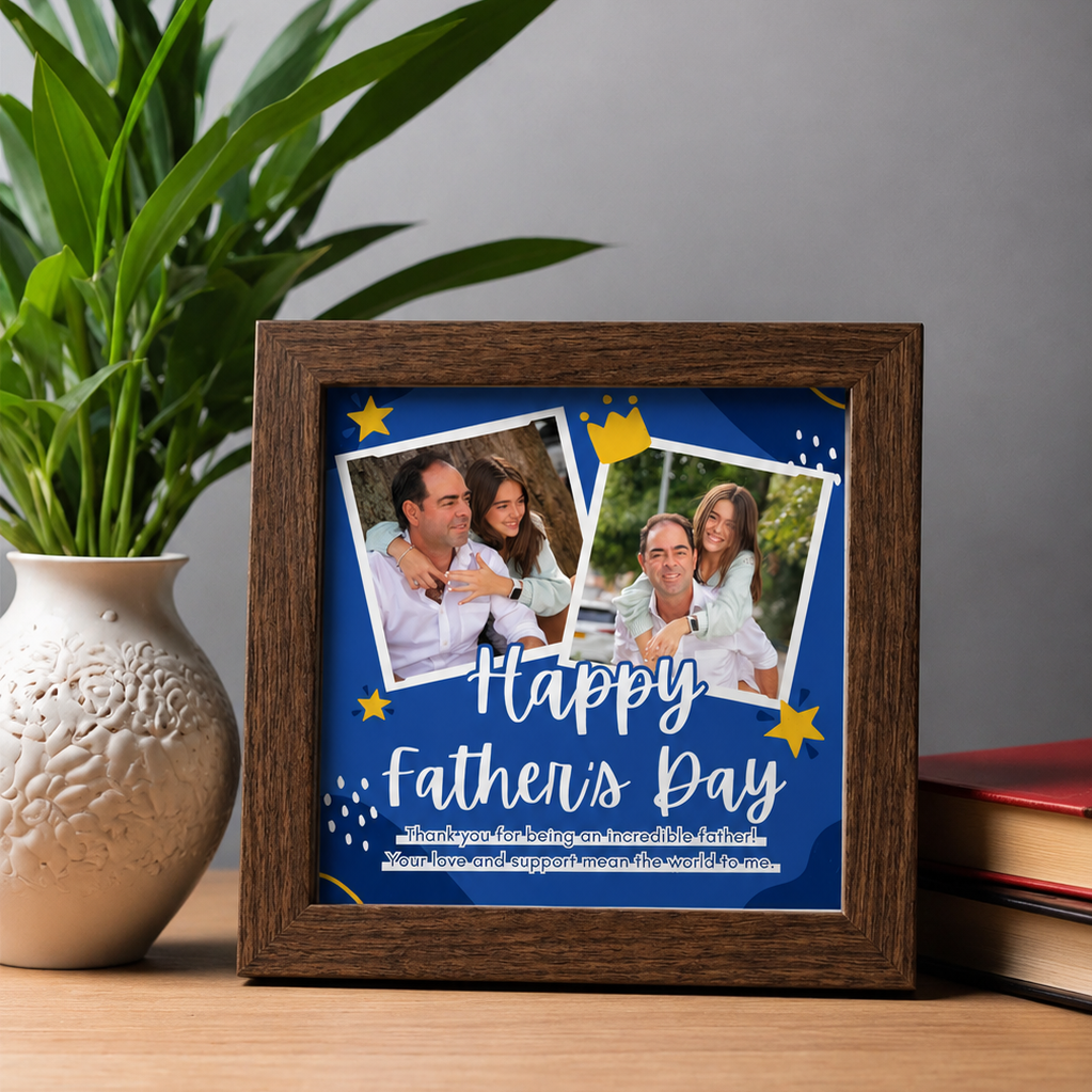 Framed 'Happy Father's Day' card with family photos on a wooden surface with a plant and books in the background.