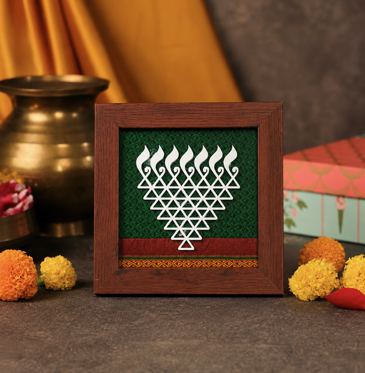Decorative frame with a geometric design on a table with decorative items.